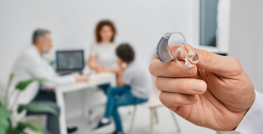 Bte Hearing Aid In Doctor Hands, Close-up. Selection Of Hearing